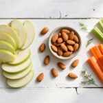 healthy snacks for weight loss - yogurt with berries, almonds, apple slices, and hummus with vegetables